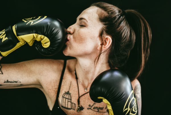 Photo of lady boxer kissing boxing glove