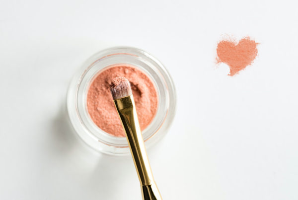Photo of makeup powder and brush with powder heart